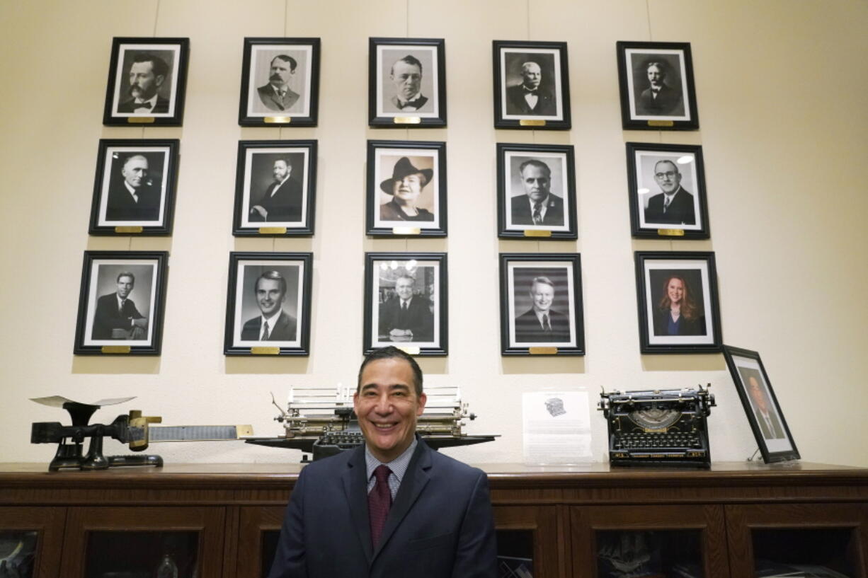 FILE - Washington Secretary of State Steve Hobbs poses in front of photos of the 15 people who previously held the office on Nov. 22, 2021, after he was sworn in at the Capitol in Olympia, Wash. Hobbs faces several challengers as he runs for election to the office he was appointed to last fall. (AP Photo/Ted S.