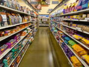 Dog food is shown in a pet store in Westfield, Ind., Tuesday, July 19, 2022. In 2018, the FDA began investigating whether the increasing popularity of grain-free dog foods had led to a sudden rise in a potentially fatal heart disease in dogs. Four years later, the FDA has reached no conclusion, but the publicity surrounding the issue has shrunk the once-promising market for grain-free dog foods.