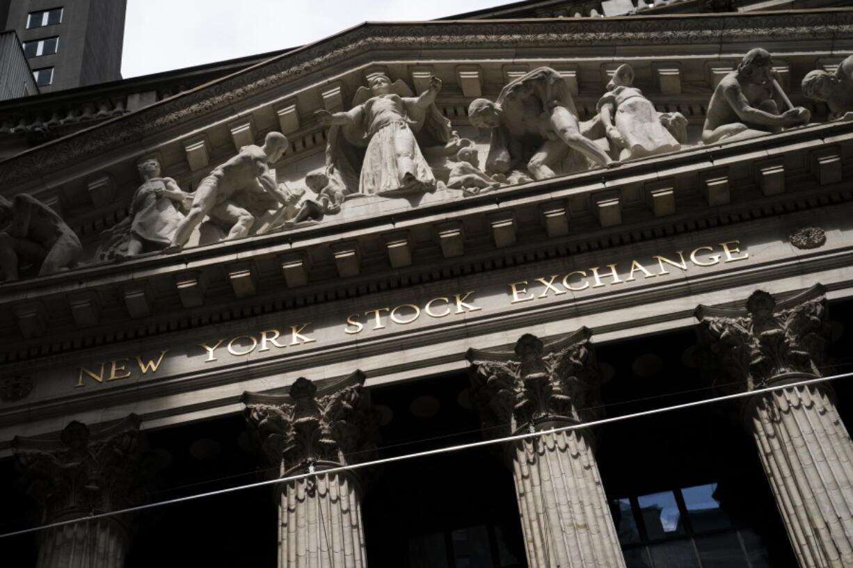 Statues adorn the facade of the New York Stock Exchange Thursday, July 14, 2022, in New York.  Stocks are drifting in mixed trading on Wall Street Friday, July 22, following weaker-than-expected readings on the economy and conflicting profit reports from some big companies.
