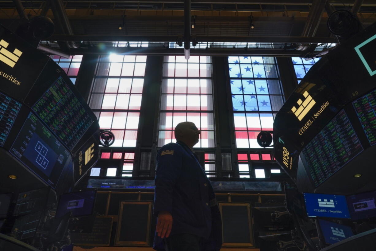 FILE - Traders work on the floor at the New York Stock Exchange in New York, Friday, July 1, 2022.  Stocks are off to a mixed start on Wall Street, Wednesday, July 20, a day after the market logged its biggest gain in more than three weeks.