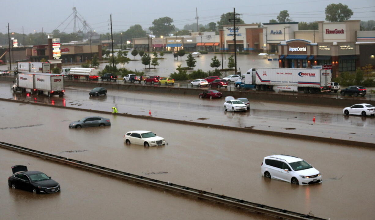 Abandoned cars are scattered by flooding across a shuttered Interstate 70 at Mid Rivers Mall Drive in St. Peters after heavy rain fell through the night and into the morning on Tuesday, July 26, 2022. (Robert Cohen/St.