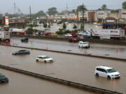 Abandoned cars are scattered by flooding across a shuttered Interstate 70 at Mid Rivers Mall Drive in St. Peters after heavy rain fell through the night and into the morning on Tuesday, July 26, 2022. (Robert Cohen/St.