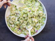 Creamy Brussels Sprouts Slaw with a mayonnaise-based dressing spiked with citrus juice, onions, mustard and Parmesan cheese.