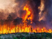 This photo provided by the fire brigade of the Gironde region (SDIS 33) shows a wildfire near Landiras, southwestern France, Sunday July 17, 2022 . Firefighters battled wildfires raging out of control in France and Spain on Sunday as Europe wilted under an unusually extreme heat wave that authorities in Madrid blamed for hundreds of deaths.