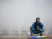 Jesse Moore cools off in the Salmon Street Springs fountain in Portland, Ore., Tuesday, July 26, 2022. Temperatures are expected to top 100 degrees F (37.8 C) on Tuesday and wide swaths of western Oregon and Washington are predicted to be well above historic averages throughout the week.