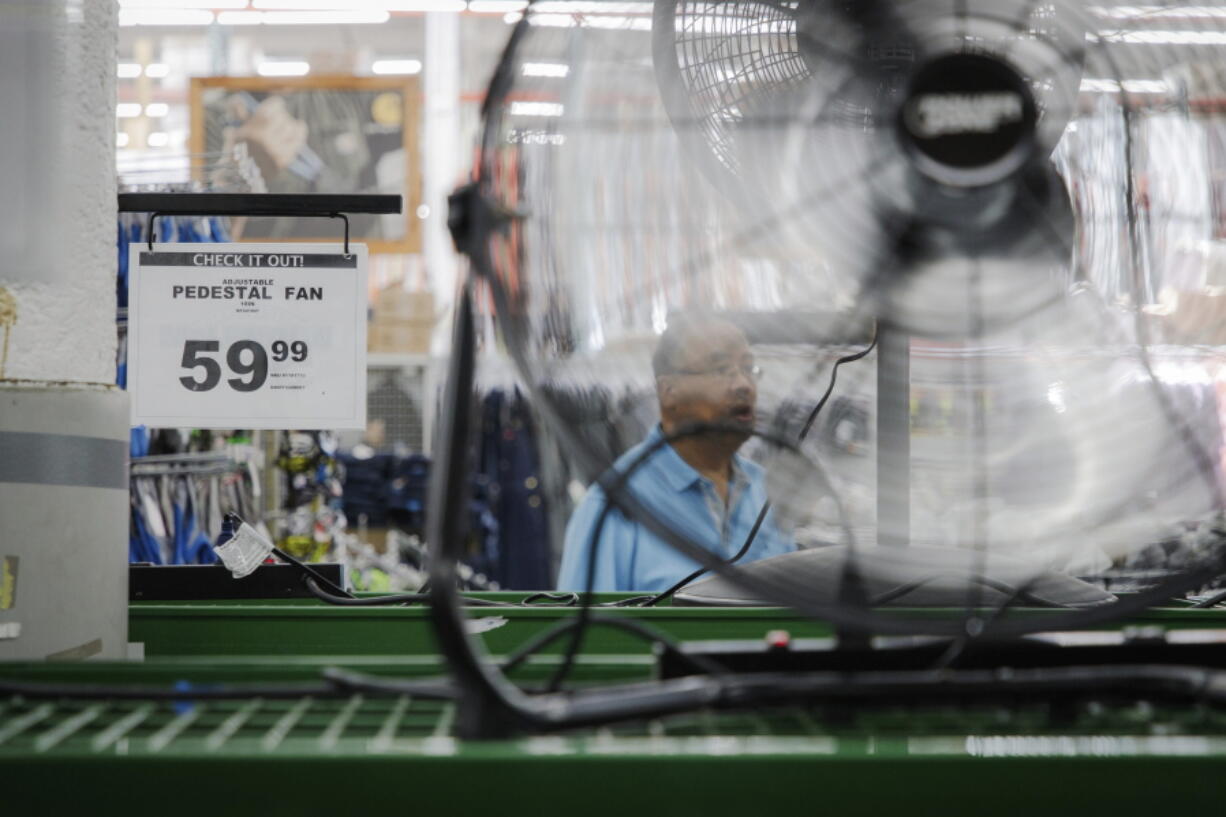 Stacks of air conditioners, fans and other cooling equipment line the entrance of McLendon Hardware in Renton, Wash., on Sunday, July 24, 2022. The Pacific Northwest is bracing for a major heat wave, with temperatures forecast to top 100 degrees Fahrenheit (37.8 Celsius) in some places this week as climate change fuels longer hot spells in a region where such events were historically uncommon.