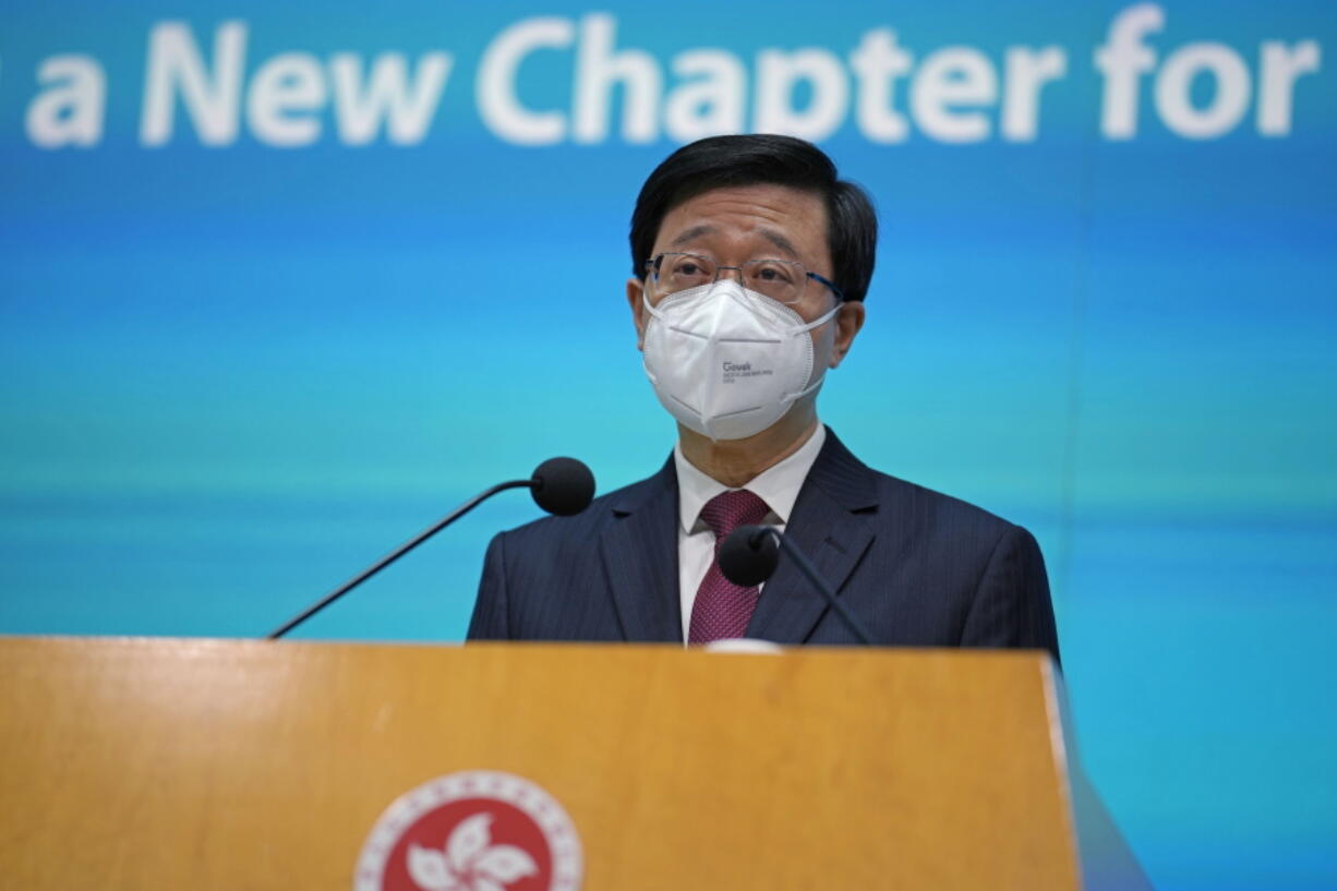 Hong Kong Chief Executive John Lee speaks during a news conference in Hong Kong, Tuesday, July 5, 2022. Lee said Tuesday in his first news conference since taking the reins that he will work towards legislating easing restrictions for travelers, but that it must be balanced with limiting the spread of the coronavirus so as not to overwhelm the healthcare system.