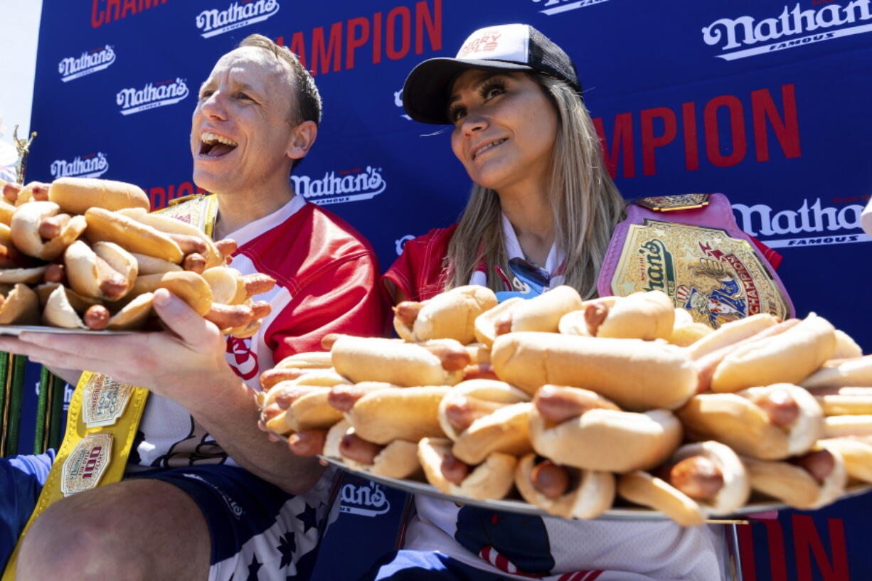 Joey Chestnut and Miki Sudo pose with 63 and 40 hot dogs, respectively, after winning the Nathan's Famous Fourth of July hot dog eating contest in Coney Island on Monday, July 4, 2022, in New York.