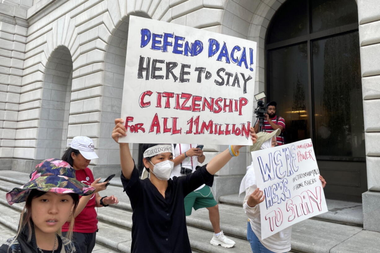 Demonstrators hold up signs outside the 5th U.S. Circuit Court of Appeals building in New Orleans on Wednesday, July 6, 2022. A panel of 5th Circuit judges heard arguments on an Obama-era program that prevents the deportation of thousands of immigrants brought into the United States as children. A federal judge in Texas last year declared the Deferred Action for Childhood Arrivals program illegal -- although he agreed to leave the program intact for those already benefiting from it while his order is appeal.