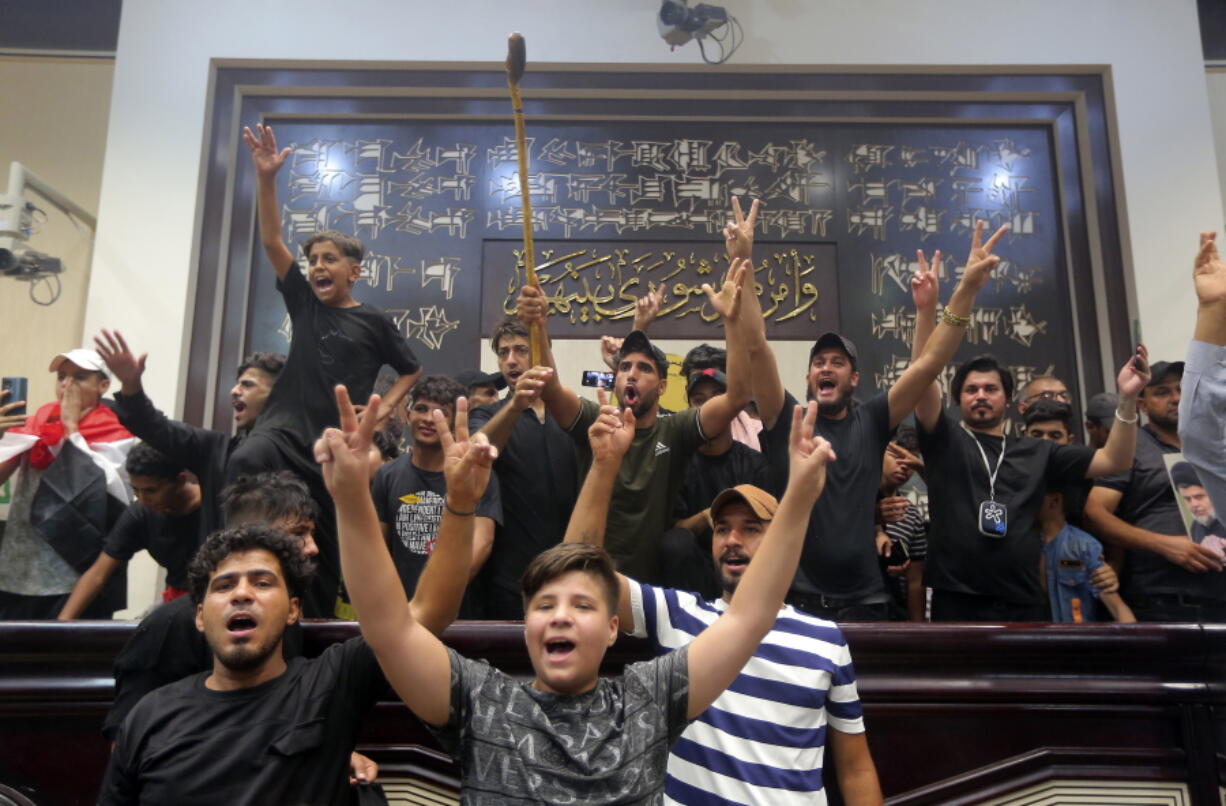 Iraqi protesters fill the parliament building in Baghdad, Iraq, Sunday, July 31, 2022. Thousands of followers of an influential Shiite cleric stormed into Iraq's parliament on Saturday, for the second time in a week, protesting government formation efforts led by his rivals, an alliance of Iran-backed groups.