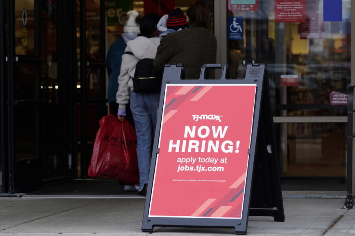 FILE - Hiring sign is displayed outside of a retail store in Vernon Hills, Ill., Saturday, Nov. 13, 2021. U.S. employers advertised fewer jobs in May 2022 as the economy has shown signs of weakening, though the overall demand for workers remained strong.  Employers advertised 11.3 million jobs at the end of May, the Labor Department said Wednesday, July 6, 2022,  down from nearly 11.7 million in March, the highest level on records that date back more than 20 years. (AP Photo/Nam Y.