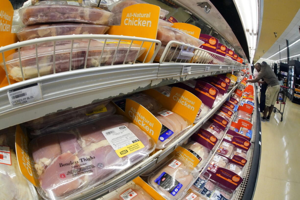 FILE - Chicken is on display in a market in Pittsburgh, July 12, 2022. The Justice Department is expected to file a lawsuit and proposed settlement against some of the largest poultry producers in the U.S. It's part of an effort to end what the government claims have been longstanding deceptive and abusive practices for workers. (AP Photo/Gene J.