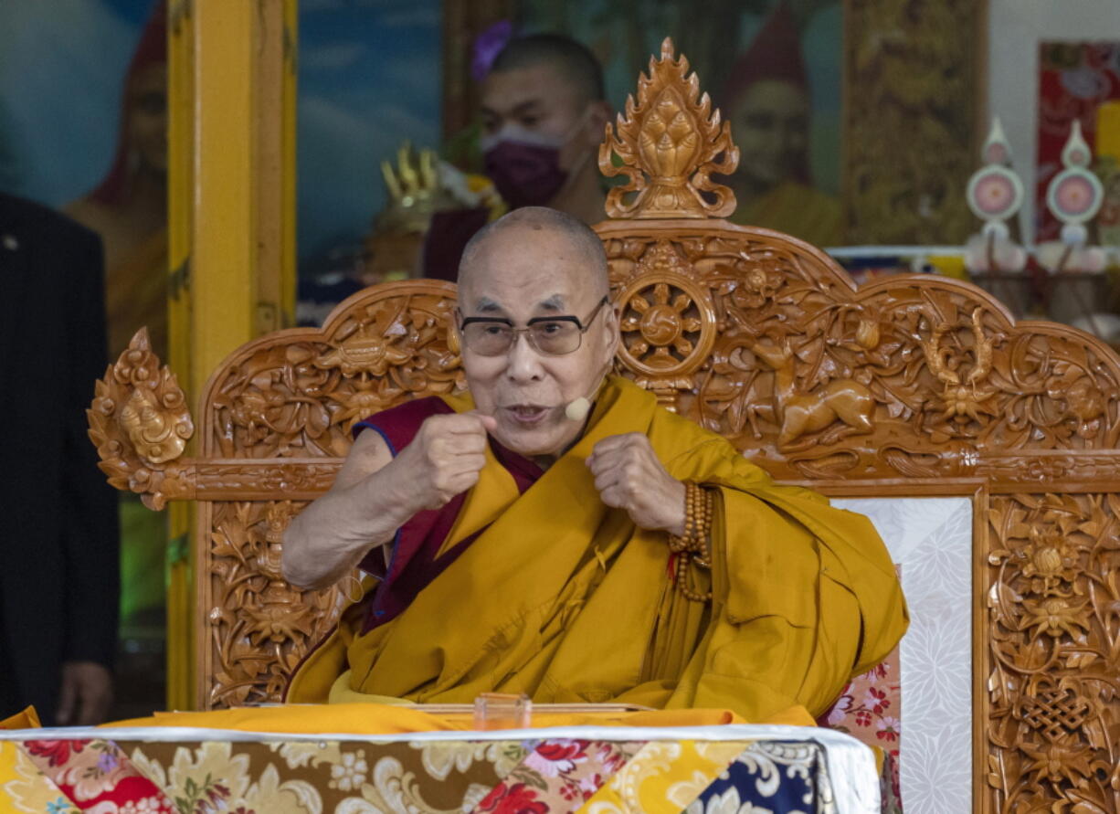 FILE- Tibetan spiritual leader the Dalai Lama gestures to indicate that he is in good health during a religious talk at the Tsuglakhang temple in Dharmsala, India, Friday, March 18, 2022. The Dalai Lama on Friday, July 15, 2022, arrived in the remote Ladakh region bordering China where he received a rousing reception. He will stay in Ladakh for about 45 days.