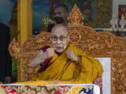 FILE- Tibetan spiritual leader the Dalai Lama gestures to indicate that he is in good health during a religious talk at the Tsuglakhang temple in Dharmsala, India, Friday, March 18, 2022. The Dalai Lama on Friday, July 15, 2022, arrived in the remote Ladakh region bordering China where he received a rousing reception. He will stay in Ladakh for about 45 days.