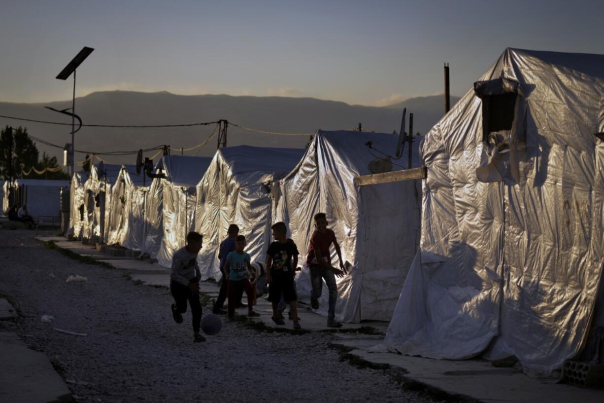 Syrian children play soccer by their tents at a refugee camp in the town of Bar Elias in the Bekaa Valley, Lebanon, July 7, 2022. The Lebanese government's plan to start deporting Syrian refugees has sent waves of fear through vulnerable refugee communities already struggling to survive in their host country. Many refugees say being forced to return to the war shattered country would be a death sentence.