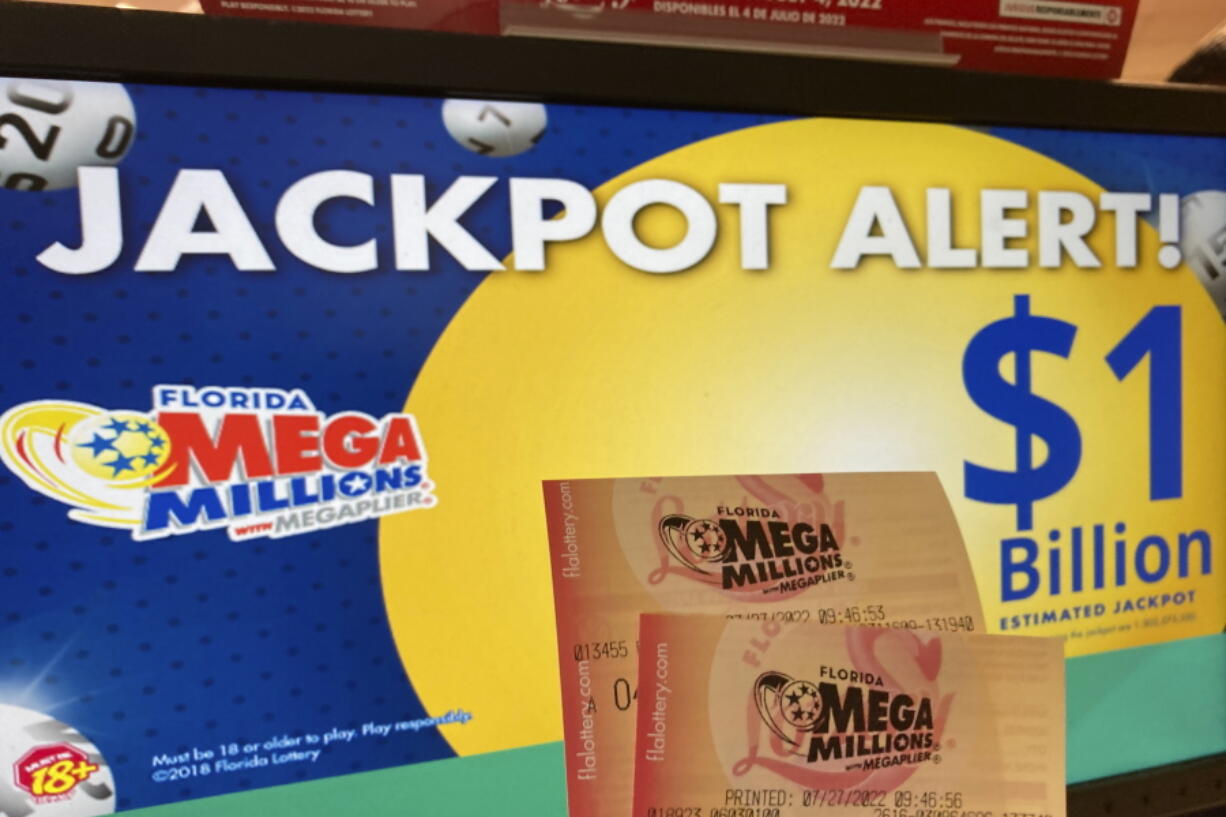 FILE - In this Wednesday, July 27, 2022 file photo, Mega Millions lottery tickets are shown at a lottery retailer in Surfside, Fla. A giant Mega Millions lottery jackpot ballooned to over $1 billion after no one matched all six numbers and won the top prize.