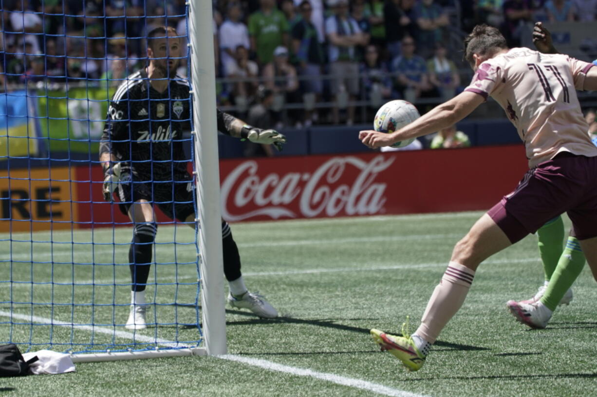 Portland Timbers forward Jaroslaw Niezgoda, right, heads the ball in for a goal against Seattle Sounders goalkeeper Stefan Frei, left, during the first half of an MLS soccer match, Saturday, July 9, 2022, in Seattle. (AP Photo/Ted S.