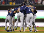 Members of the Seattle Mariners celebrate after winning the second game of a baseball doubleheader against the Washington Nationals, Wednesday, July 13, 2022, in Washington. Seattle won 2-1.