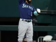 Seattle Mariners' J.P. Crawford celebrates hitting an RBI single during the 10th inning of the team's baseball game against the Texas Rangers, Saturday, July 16, 2022, in Arlington, Texas. The Mariners won 3-2.