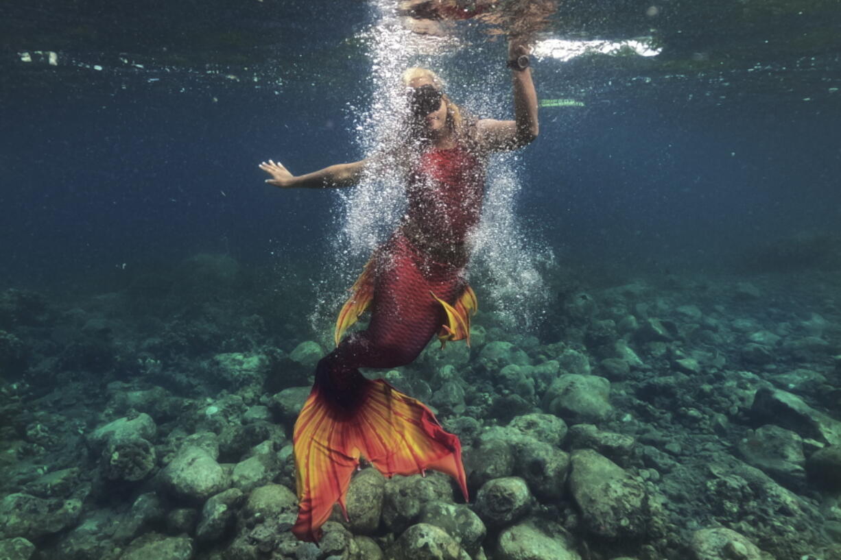 Queen Pangke Tabora swims in her mermaid suit while she conducts a mermaiding class in front of the Ocean Camp in Mabini, Batangas province, Philippines on May 22.