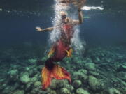 Queen Pangke Tabora swims in her mermaid suit while she conducts a mermaiding class in front of the Ocean Camp in Mabini, Batangas province, Philippines on May 22.