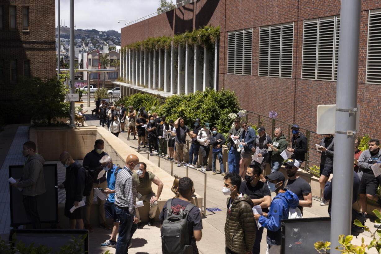 FILE - People stand in long lines to receive the monkeypox vaccine at San Francisco General Hospital in San Francisco, Tuesday, July 12, 2022.