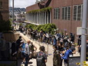 FILE - People stand in long lines to receive the monkeypox vaccine at San Francisco General Hospital in San Francisco, Tuesday, July 12, 2022.