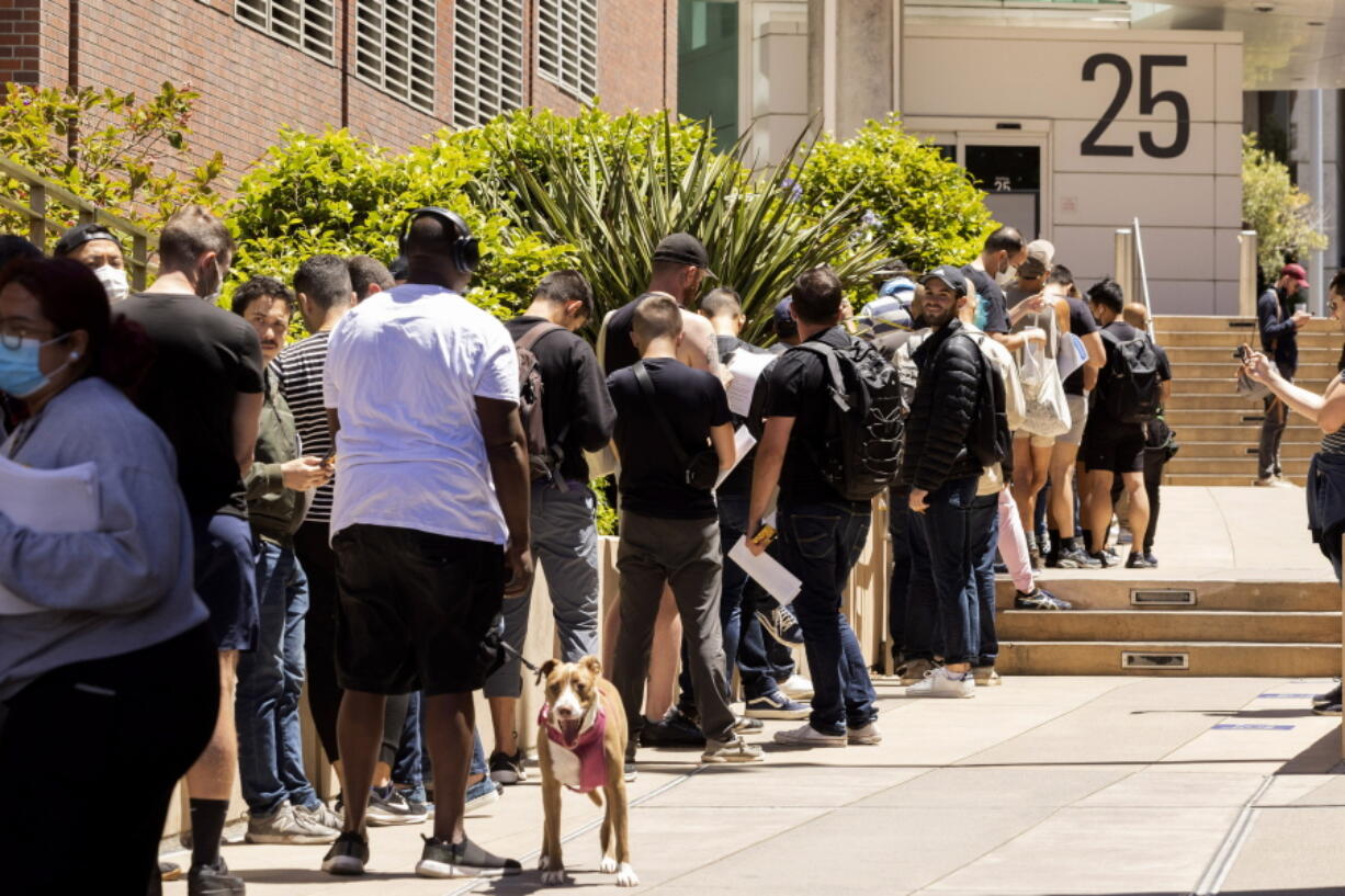 People stand in long lines to receive the monkeypox vaccine at San Francisco General Hospital in San Francisco, Tuesday, July 12, 2022.