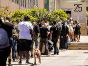 People stand in long lines to receive the monkeypox vaccine at San Francisco General Hospital in San Francisco, Tuesday, July 12, 2022.