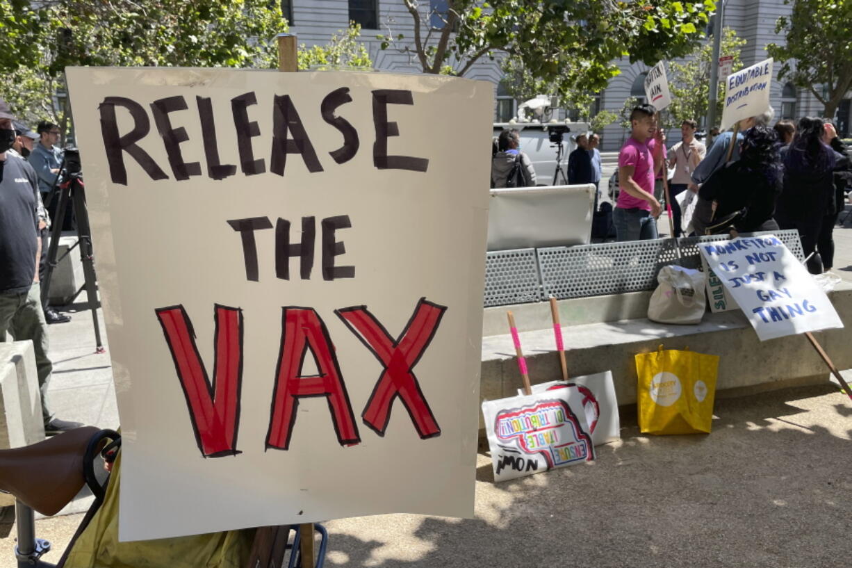 FILE - A sign urges the release of the monkeypox vaccine during a protest in San Francisco, July 18, 2022. The mayor of San Francisco announced a legal state of emergency Thursday, July 28, 2022, over the growing number of monkeypox cases. Public health officials warn that moves by rich countries to buy large quantities of monkeypox vaccine, while declining to share doses with Africa, could leave millions of people unprotected against a more dangerous version of the disease and risk continued spillovers of the virus into humans.