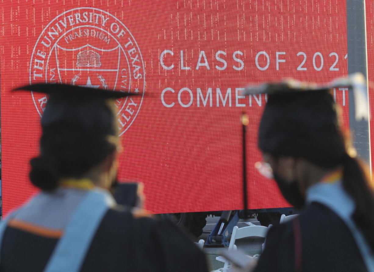 FILE - Graduates of the University of Texas Rio Grande Valley attend their commencement ceremony at the schools parking lot on Friday, May 7, 2021, in Edinburg, Texas.   A deadline is fast approaching for teachers, librarians, nurses and others who work in public service to apply to have their student loan debt forgiven. New figures from the U.S. Department of Education show 145,000 borrowers have had the remainder of their debt canceled through the Public Service Loan Forgiveness program.