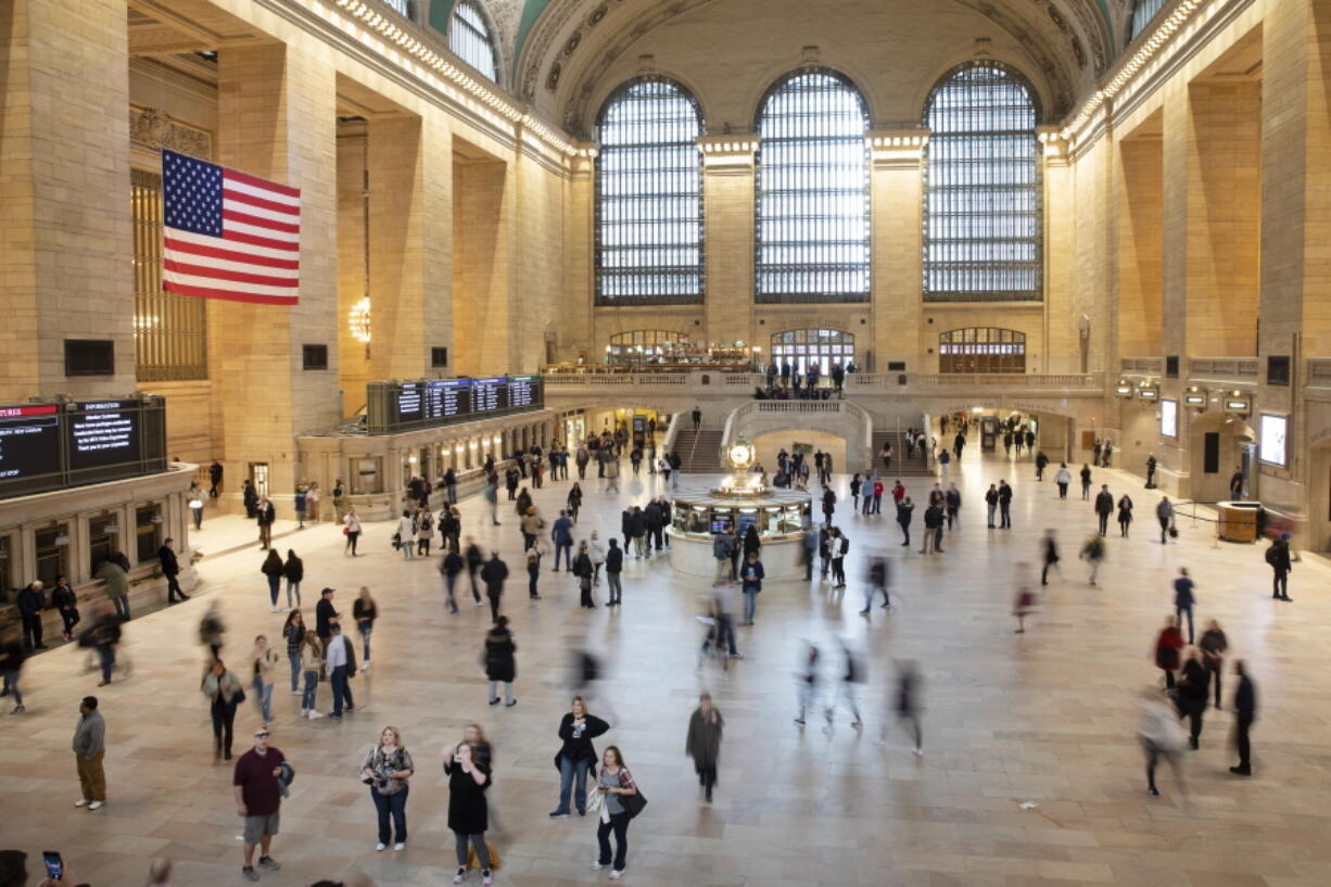 FILE - Commuters pass through Grand Central Terminal on March 10, 2020 in New York. Millennials are known for changing jobs often, but how does that affect their retirement savings? That depends on several factors. It's a good idea to weigh the pros and cons before taking the leap.