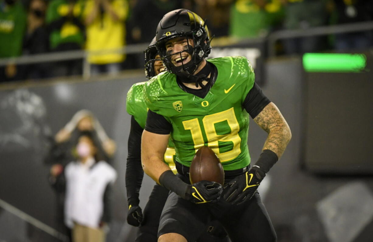 FILE - Oregon Ducks tight end Spencer Webb (18) is shown after a touchdown during an NCAA college football game against Arizona on Sept. 25, 2021, in Eugene, Ore. Webb has died after falling and striking his head on rock slides at a popular swimming lake near Eugene, Oregon. Authorities say the 22-year-old was unresponsive when they arrived at Triangle Lake on Wednesday, July 13, 2022, and found him about 100 yards down a steep trail.