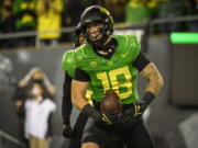 FILE - Oregon Ducks tight end Spencer Webb (18) is shown after a touchdown during an NCAA college football game against Arizona on Sept. 25, 2021, in Eugene, Ore. Webb has died after falling and striking his head on rock slides at a popular swimming lake near Eugene, Oregon. Authorities say the 22-year-old was unresponsive when they arrived at Triangle Lake on Wednesday, July 13, 2022, and found him about 100 yards down a steep trail.