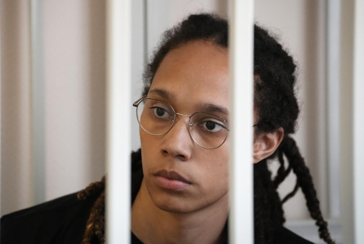 WNBA star and two-time Olympic gold medalist Brittney Griner sits in a cage at a court room prior to a hearing, in Khimki just outside Moscow, Russia, Wednesday, July 27, 2022. American basketball star Brittney Griner returned Wednesday to a Russian courtroom for her drawn-out trial on drug charges that could bring her 10 years in prison of convicted.