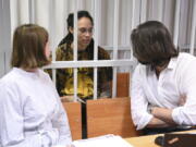 WNBA star and two-time Olympic gold medalist Brittney Griner speaks with her lawyers Alexander Boykov, right, and Maria Blagovolina at a court room prior to a hearing in the Khimki district court, just outside Moscow, Russia, Friday, July 15, 2022. Griner was arrested in February at the Russian capital's Sheremetyevo Airport when customs officials said they found vape canisters with cannabis oil in her luggage. She has been jailed since then, facing up to 10 years in prison if convicted.