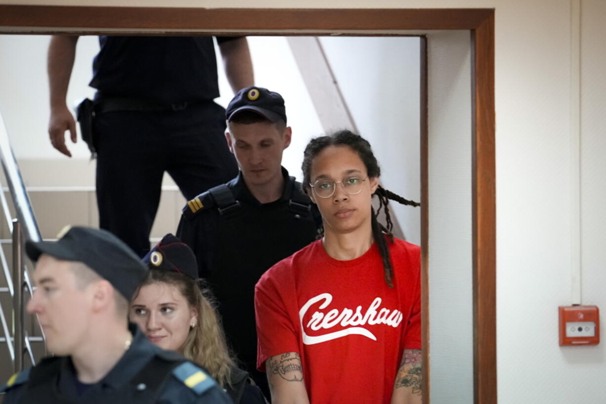 WNBA star and two-time Olympic gold medalist Brittney Griner is escorted to a courtroom for a hearing, in Khimki outside Moscow, Russia, Thursday, July 7, 2022. Griner on Thursday pleaded guilty to drug possession and smuggling during her trial in Moscow but said she had no intention of committing a crime, Russian news agencies reported.