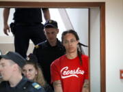 WNBA star and two-time Olympic gold medalist Brittney Griner is escorted to a courtroom for a hearing, in Khimki outside Moscow, Russia, Thursday, July 7, 2022. Griner on Thursday pleaded guilty to drug possession and smuggling during her trial in Moscow but said she had no intention of committing a crime, Russian news agencies reported.