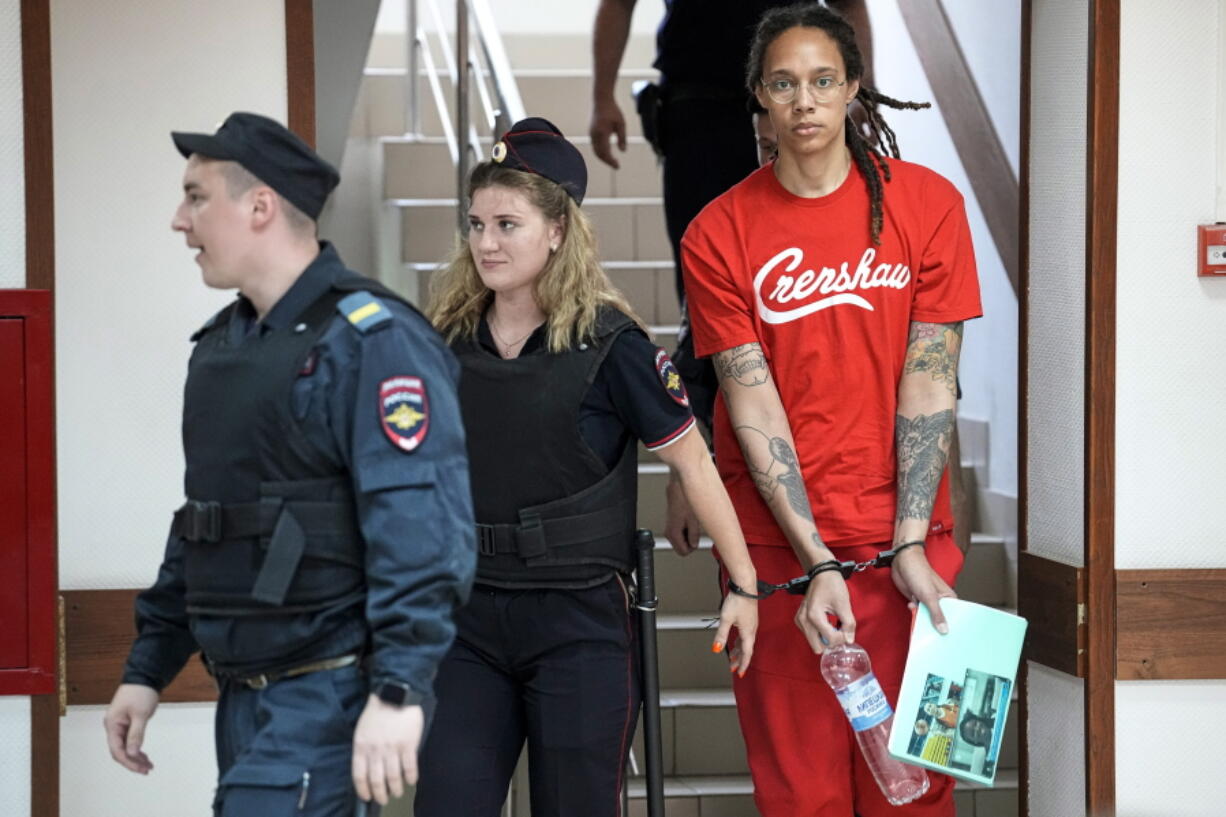 WNBA star and two-time Olympic gold medalist Brittney Griner is escorted to a courtroom for a hearing, in Khimki just outside Moscow, Russia, Thursday, July 7, 2022. Jailed American basketball star Brittney Griner returns to a Russian court on Thursday amid a growing chorus of calls for Washington to do more to secure her release nearly five months after being arrested on drug charges.