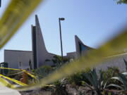 FILE - Crime scene tape surrounds Geneva Presbyterian Church on Tuesday, May 17, 2022, in Laguna Woods, Calif. A gunman opened fire on May 15 during a luncheon at the church, killing one and injuring five other members of a Taiwanese congregation that met there.