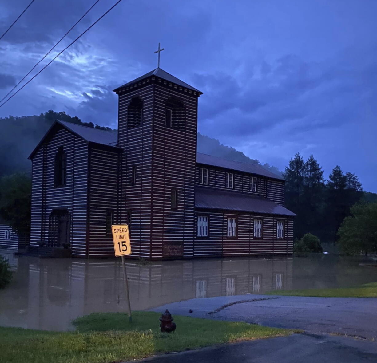 This image provided by Marlene Abner Stokely shows flooding by the Buckhorn Log Cathedral, Thursday, July 28, 2022 in Buckhorn, Ky. Heavy rains have caused flash flooding and mudslides as storms pound parts of central Appalachia. Kentucky Gov. Andy Beshear says it's some of the worst flooding in state history.