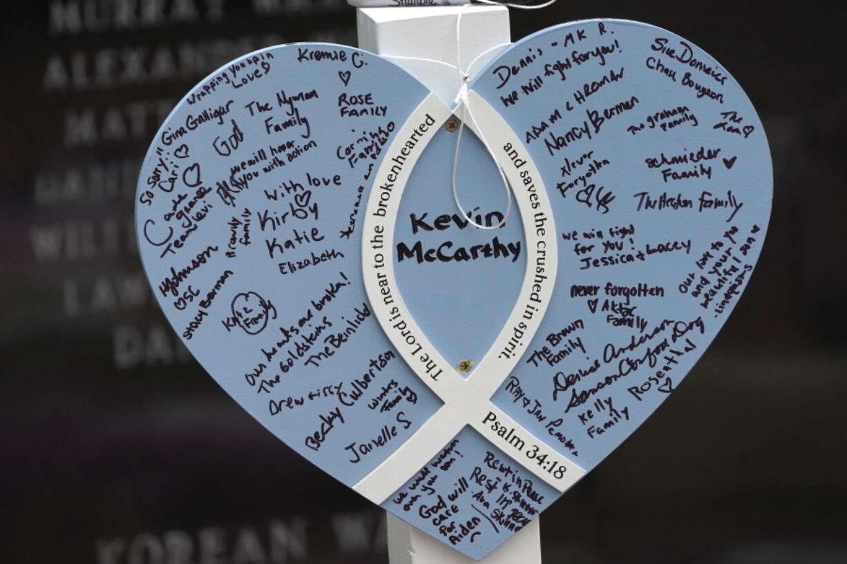 A Memorial for Kevin McCarthy, one of seven people killed in the Highland Park, Ill., Fourth of July parade mass shooting, stands within a War Memorial, Wednesday, July 6, 2022, in Highland Park. Funeral services for the seven people killed by a gunman at an Independence Day parade are set to conclude with family and friends gathering in suburban Chicago to remember McCarthy. McCarthy and his wife Irina, who was also killed, leave behind a 2-year-old son, Aiden, whose story prompted thousands of people to donate money for the orphaned boy.