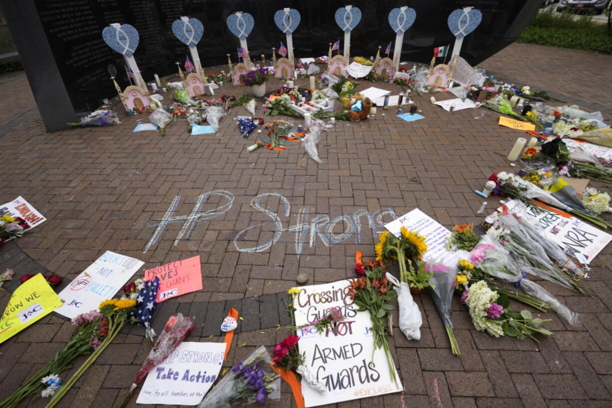 A memorial to the seven people killed and others injured in Monday's Fourth of July mass shooting grows at a veterans memorial Wednesday, July 6, 2022, in Highland Park, Ill.