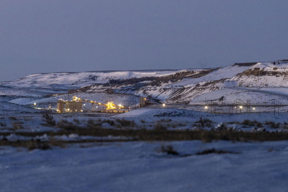 FILE - Lights illuminate a coal mine at twilight, Jan. 13, 2022, in Kemmerer, Wyo. With the nearby coal-fired Naughton Powerplant being decommissioned in 2025, the fate of the coal mine and its workers is uncertain. More than 500 days into his presidency, Joe Biden's hope for saving the Earth from the most devastating effects of climate change may not be dead. But it's not far from it after a Supreme Court ruling not only limited the Environmental Protection Agency's ability to regulate pollution by power plants, but also suggests the court is poised to block other efforts to limit the climate-wrecking fumes emitted by oil, gas and coal.