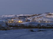 FILE - Lights illuminate a coal mine at twilight, Jan. 13, 2022, in Kemmerer, Wyo. With the nearby coal-fired Naughton Powerplant being decommissioned in 2025, the fate of the coal mine and its workers is uncertain. More than 500 days into his presidency, Joe Biden's hope for saving the Earth from the most devastating effects of climate change may not be dead. But it's not far from it after a Supreme Court ruling not only limited the Environmental Protection Agency's ability to regulate pollution by power plants, but also suggests the court is poised to block other efforts to limit the climate-wrecking fumes emitted by oil, gas and coal.