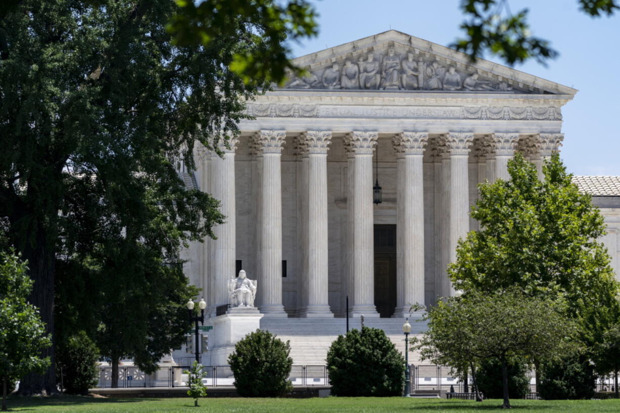 FILE - The Supreme Court is seen on Capitol Hill in Washington, July 14, 2022. About 2 in 3 Americans say they favor term limits or a mandatory retirement age for Supreme Court justices, according to a new poll that finds a sharp increase in the percentage of Americans saying they have "hardly any" confidence in the court. (AP Photo/J.