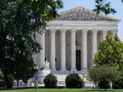 FILE - The Supreme Court is seen on Capitol Hill in Washington, July 14, 2022. About 2 in 3 Americans say they favor term limits or a mandatory retirement age for Supreme Court justices, according to a new poll that finds a sharp increase in the percentage of Americans saying they have "hardly any" confidence in the court. (AP Photo/J.