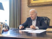 In this image provided by the White House, President Joe Biden speaks with Sen. Bob Casey, D-Pa., on the phone from the Treaty Room in the residence of the White House Thursday, July 21, 2022, in Washington. Biden says he's "doing great" after testing positive for COVID-19. The White House said Biden is experiencing "very mild symptoms," including a stuffy nose, fatigue and cough. He's taking Paxlovid, an antiviral drug designed to reduce the severity of the disease.