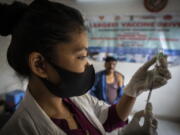 FILE- A nurse prepares to administer vaccine for COVID-19 at a private vaccination center in Gauhati, India, April 10, 2022. The quickly changing coronavirus has spawned yet another super contagious omicron mutant that's worrying scientists as it gains ground in India and pops up in numerous other countries, including the United States. Scientists say the variant, which is called BA.2.75, may be able to spread rapidly and get around immunity from vaccines and previous infection.