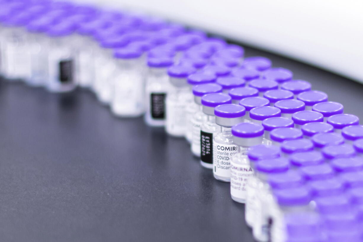 FILE - In this March 2021 photo provided by Pfizer, vials of the Pfizer-BioNTech COVID-19 vaccine are prepared for packaging at the company's facility in Puurs, Belgium. According to a study published Thursday. June 23, 2022 in the journal Lancet Infectious Diseases, nearly 20 million lives were saved by COVID-19 vaccines during their first year, but even more deaths could have been prevented if global targets had been reached.